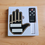 Mens gesture light variant with thumb detail and remote control in its packaging